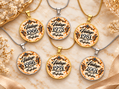 Six Aged to Perfection Luxe Edition Champagne birth year necklaces in silver and gold finish on white marble